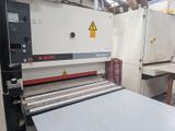 an image of a machine in a factory with a sheet of paper