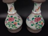 two vases that are sitting on a black surface
