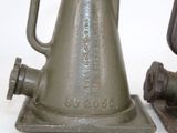 two old metal bells sitting next to each other on a table