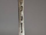 a silver spoon with a fork sticking out of it