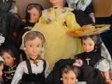 a lot of dolls that are sitting together on a table