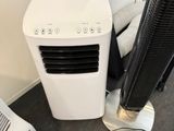 un climatiseur blanc posé à côté d'un climatiseur noir et blanc