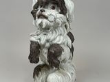 a figurine of a dog sitting on its hind legs