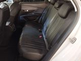 the back seat of a white car with a black seat cover