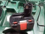 a green boat with a battery in it and a mouse in it