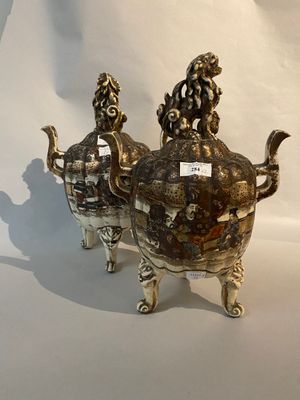 two silver objects that are sitting on a white surface