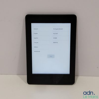 a tablet computer sitting on top of a white table