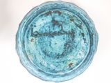 a close up of a blue bowl on a white surface