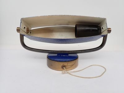 a black and white purse with a blue handle on a white table