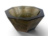 a glass bowl that is sitting on a white surface