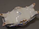 a white and blue bowl with a fish design on it