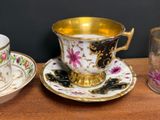 three cups and saucers sitting on a wooden table