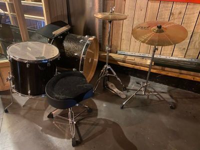 a drum set up in the corner of a room