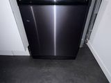 a black dishwasher in a small kitchen