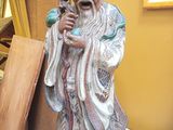 a statue of a man with a beard holding a vase