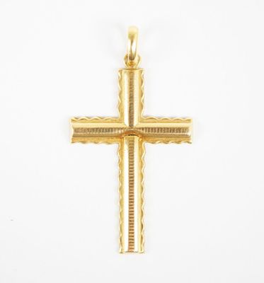 an image of a gold cross pendant on a white background