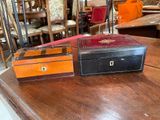 two boxes sitting on a wooden table in a room