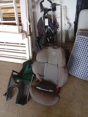 a baby car seat, stroller, and other items in a room