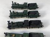 five toy trains sitting on a white surface next to each other