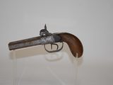 an old gun with a wooden handle on a clear stand