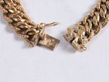 gold chain bracelet with a padlock and a chain link