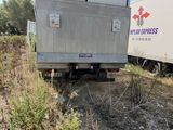 two trailers that are parked on the side of the road