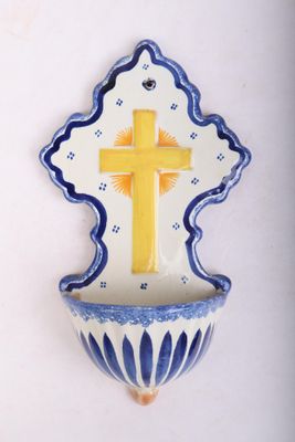a small blue and white bowl with a yellow cross on it