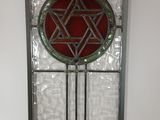 a stained glass window with a star of david on it