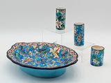a blue bowl and four cups sitting on a table