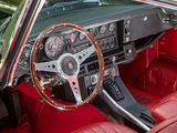 dashboard of a classic car with red leather seats and steering wheel