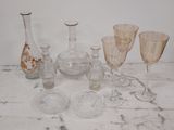 a marble table with a bunch of glass vases on it