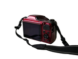 a red camera with a black strap attached to it