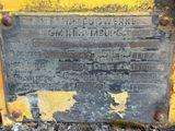 a close up of a sign on a yellow tractor