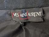 the back of a black skirt with a red and white logo on it