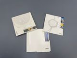 three white folders sitting on top of a table next to each other