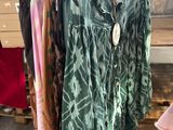 a rack of clothes on display in a clothing store