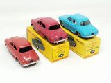 three toy cars sitting on top of a box