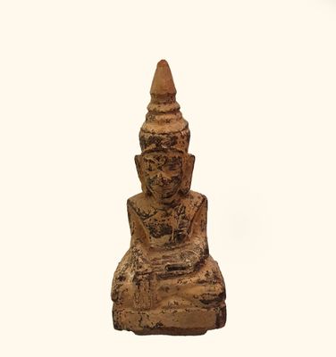 a small statue of a person sitting on a chair