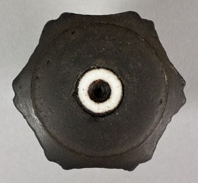 a close up of a metal object with a hole in it