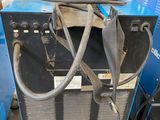 an image of a welding machine with a hose attached to the back of it