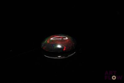 an image of a red and black object in the dark