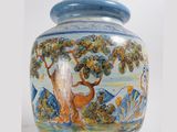 a blue and white vase with a painting on it