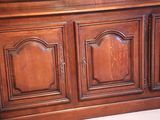 a wooden cabinet with a mirror on top of it