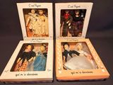 three boxed dolls of different styles and colors are in a box