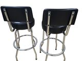 pair of black leather bar stools with chrome legs