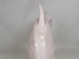 a pink pig head vase sitting on a white table