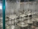 many empty wine glasses sitting on a shelf in a store