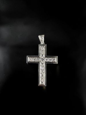 a diamond cross pendant on a black background