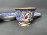 two cups and a saucer are sitting on a table