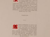 a close up of a book with a red cross on it
